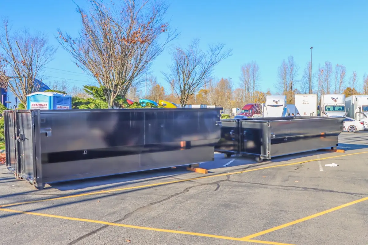 Professional dumpster rental service with roll-off container on residential driveway in Lower Oxford